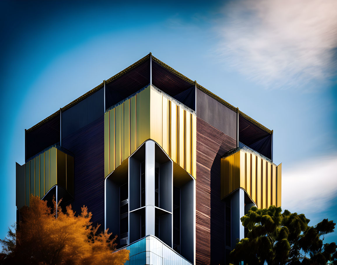 Colorful geometric modern building under blue sky with clouds and trees.