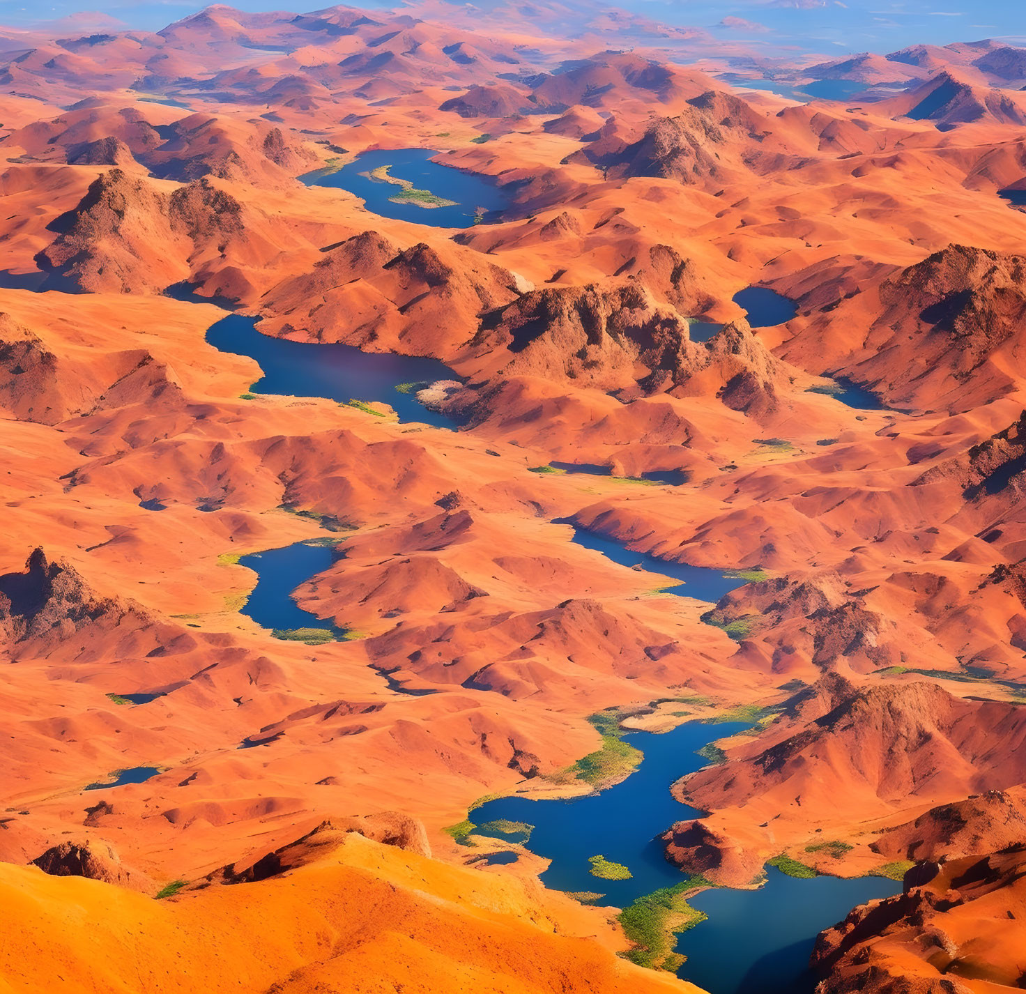 Sinuous river meandering through vibrant orange desert landscape