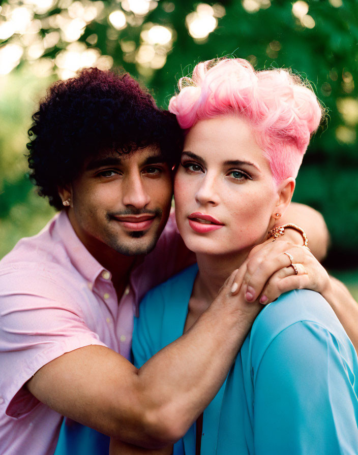 Couple with Curly and Pink Short Hair Embracing on Green Background