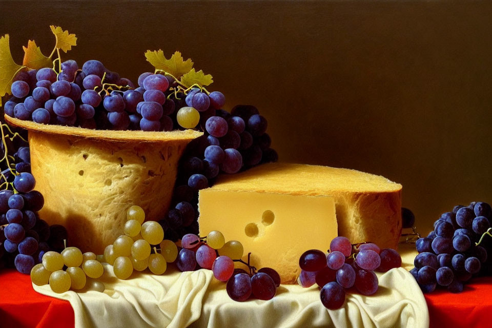 Still life image: wheel of cheese, grapes, grape leaves on cloth