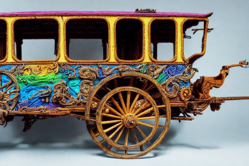 Colorful Ornate Miniature Carriage with Gold Accents and Detailed Wheels