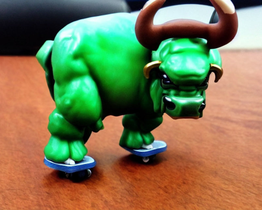 Green Bull Toy Figure on Mini Skateboards on Desk Surface