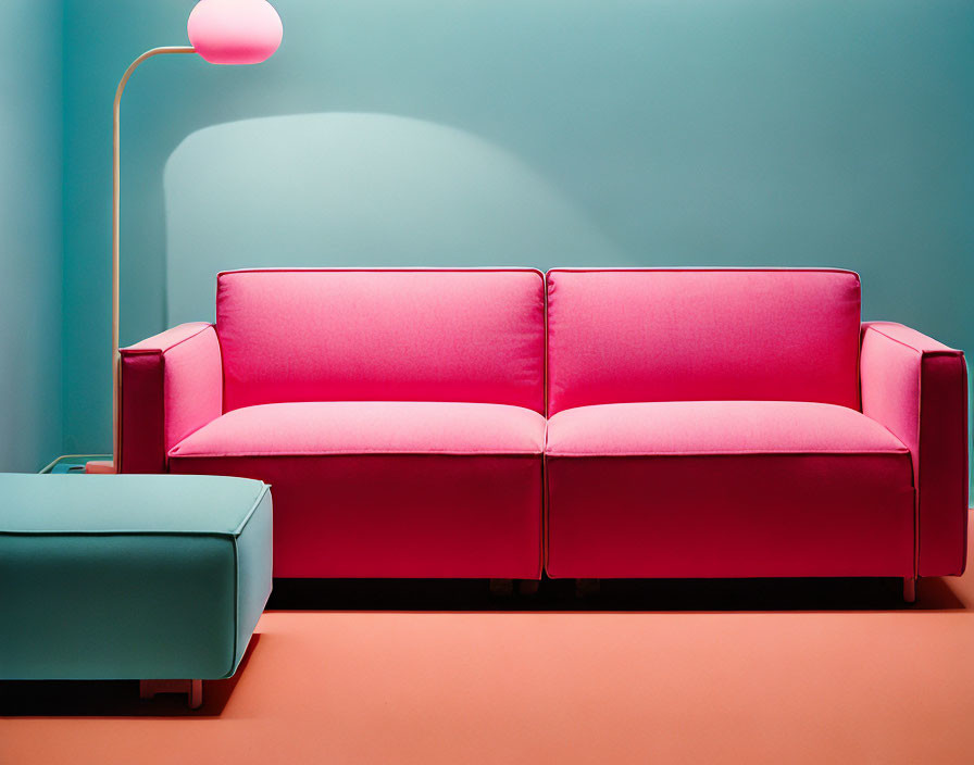 Colorful Pink Sofa on Teal Wall with Soft Lamp Glow and Blue Ottoman
