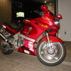 Red Sports Motorcycle with Chrome Exhausts and Black Seats