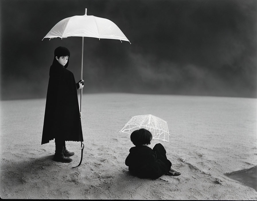 Monochrome image of two children with white umbrellas