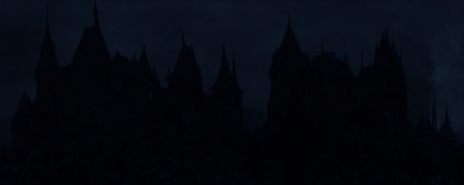 Gothic castle silhouette under gloomy sky