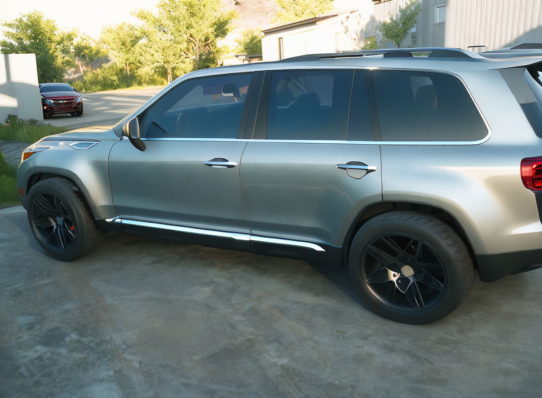 Silver SUV with black rims parked on concrete driveway in residential setting.