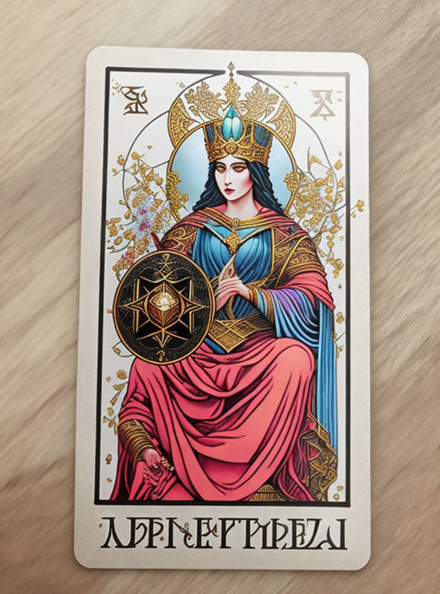 Tarot card with robed figure holding pentacle & golden designs