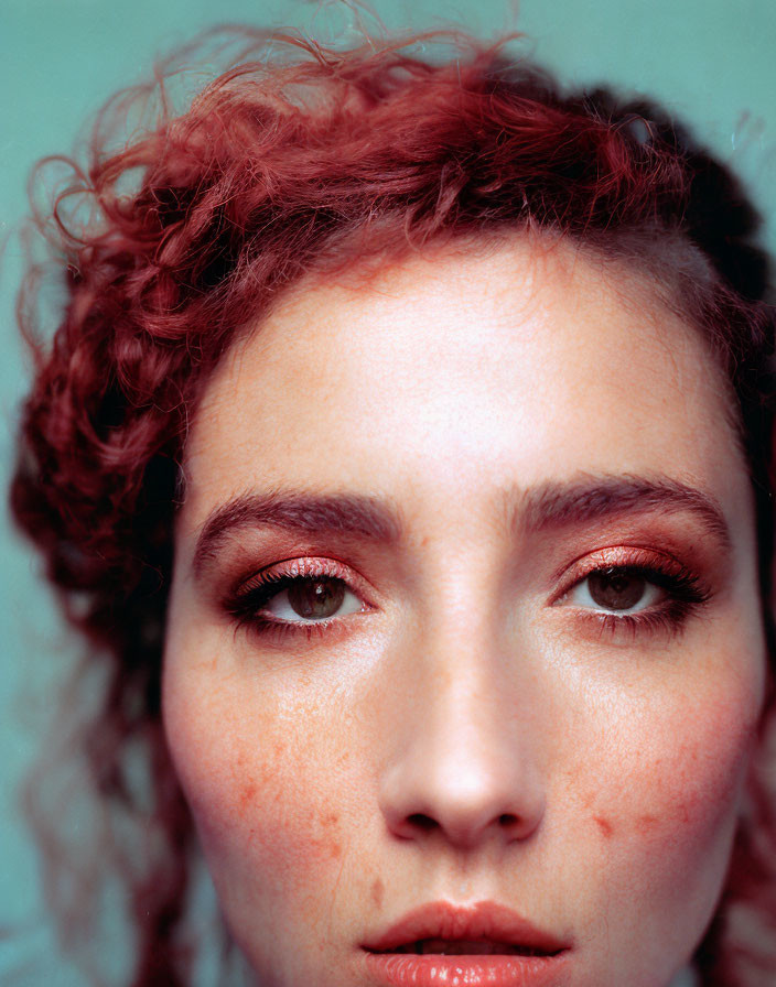 Person with Red Curly Hair and Intense Gaze in Portrait with Freckles and Eye Shadow