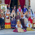 Traditional Eastern European figures in colorful attire against stained glass backdrop
