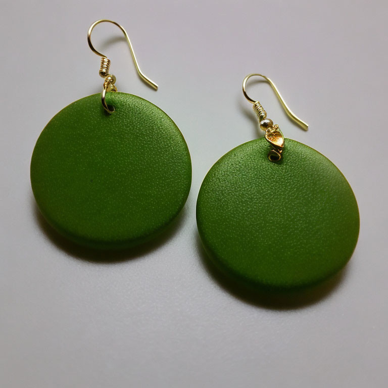 Circular Green Matte Earrings with Gold Hooks on White Surface