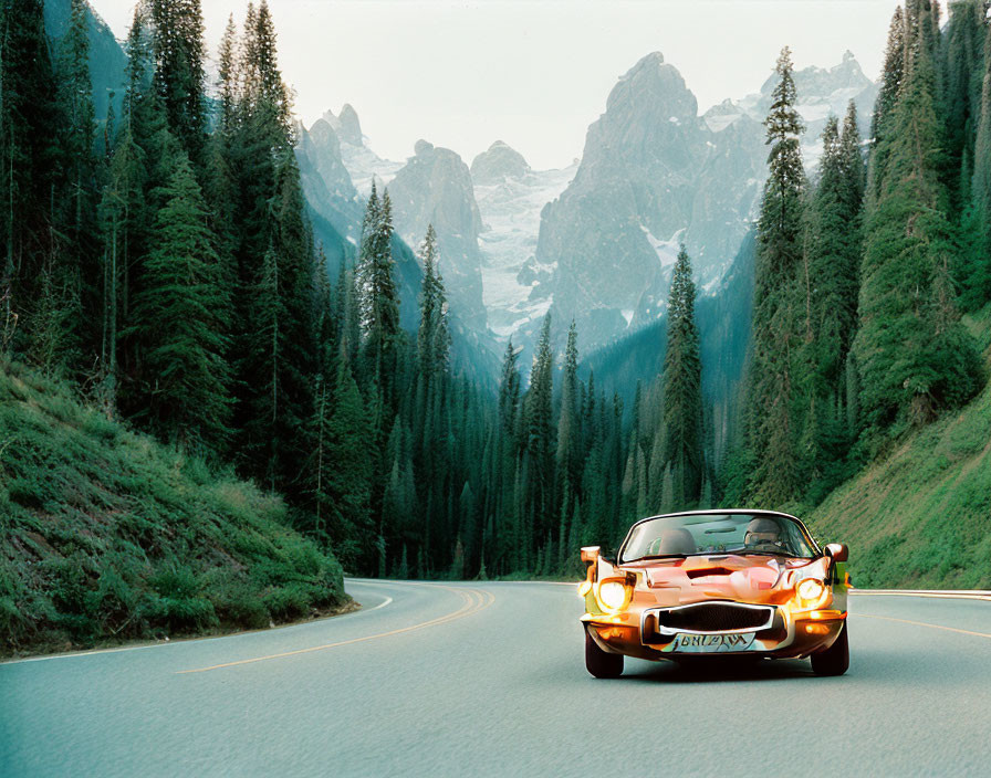 Sports car on winding road through forested mountainous area