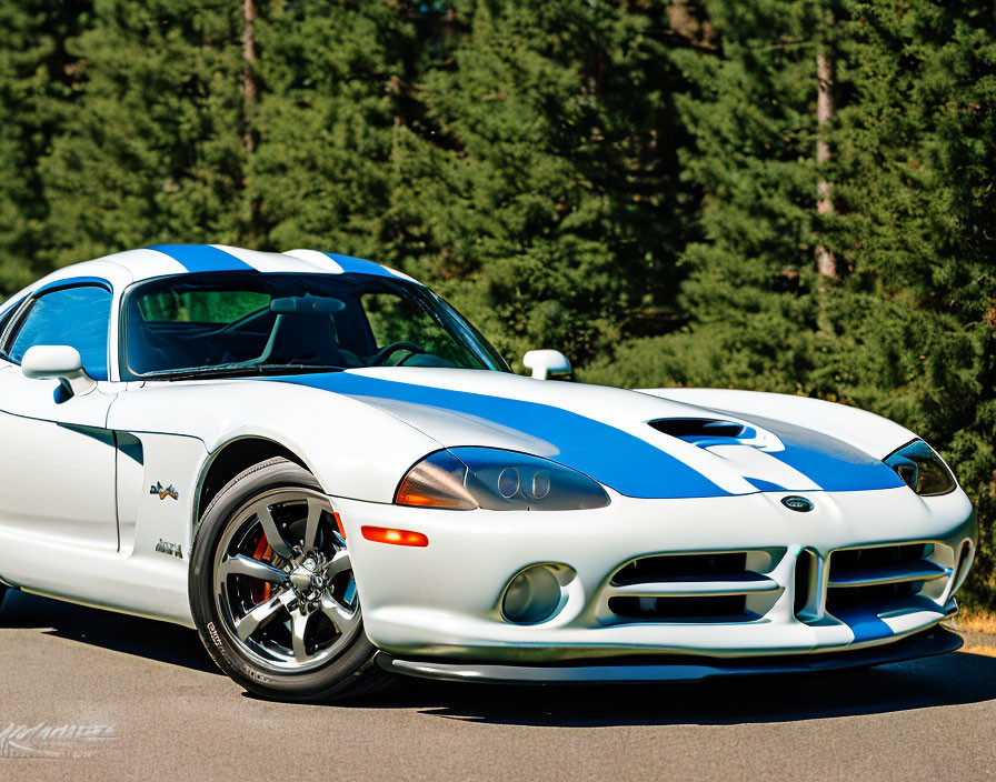 White Sports Car with Blue Stripes and Logo Parked Outdoors