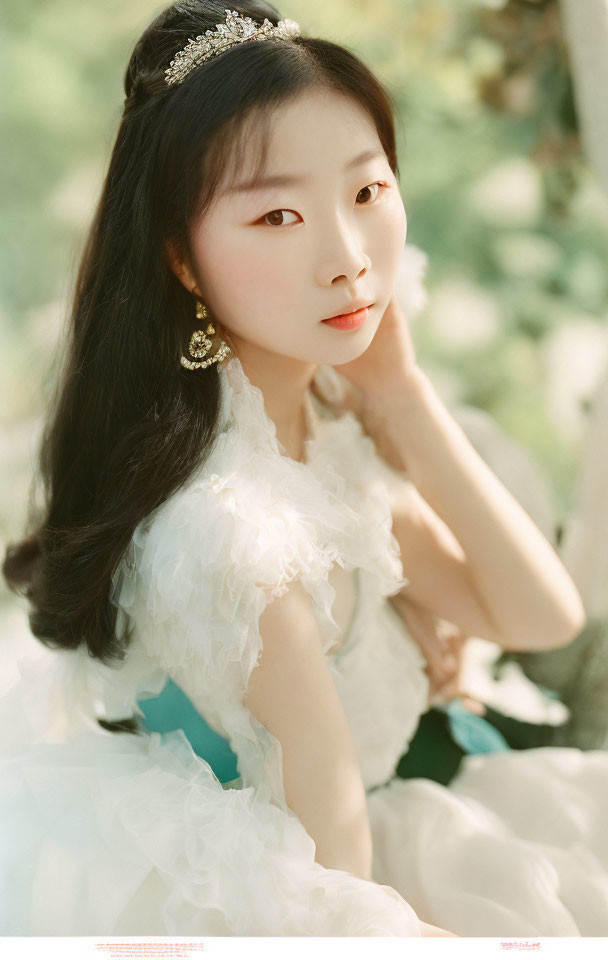 Serene portrait of elegant individual in tiara and white ruffled dress