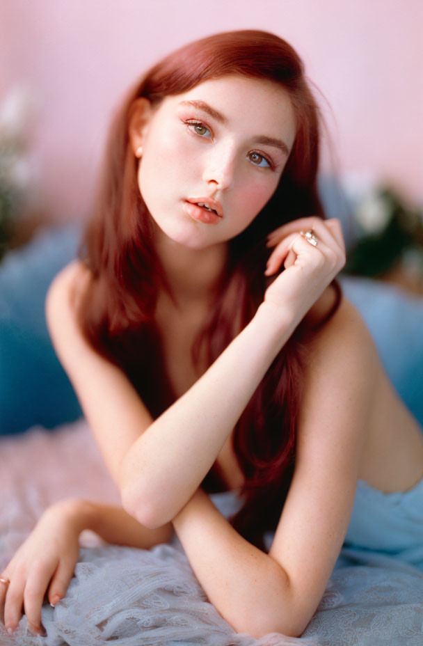 Red-Haired Woman Gazing at Camera on Pink Background