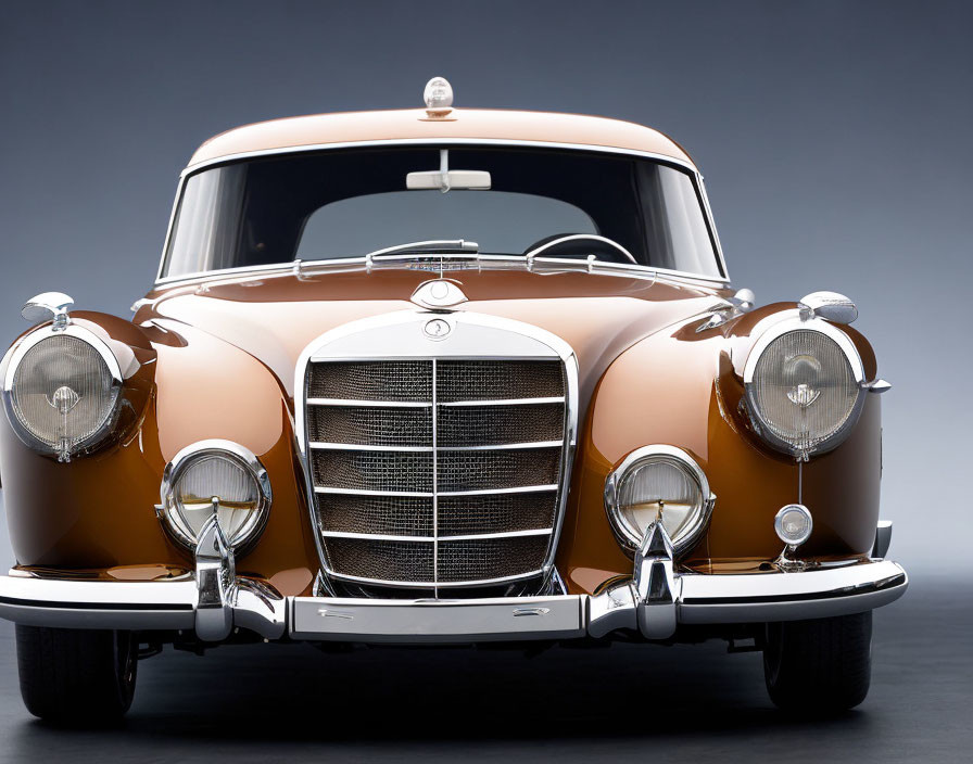 Classic Mercedes-Benz Front View with Chrome Grille and Bumper on Gray Background