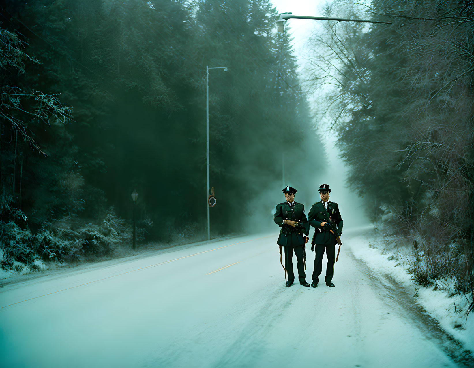 Three uniformed individuals marching on snowy road with misty trees
