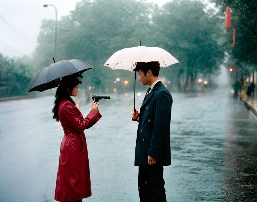 Woman in red coat aims gun at man under umbrella on rainy street
