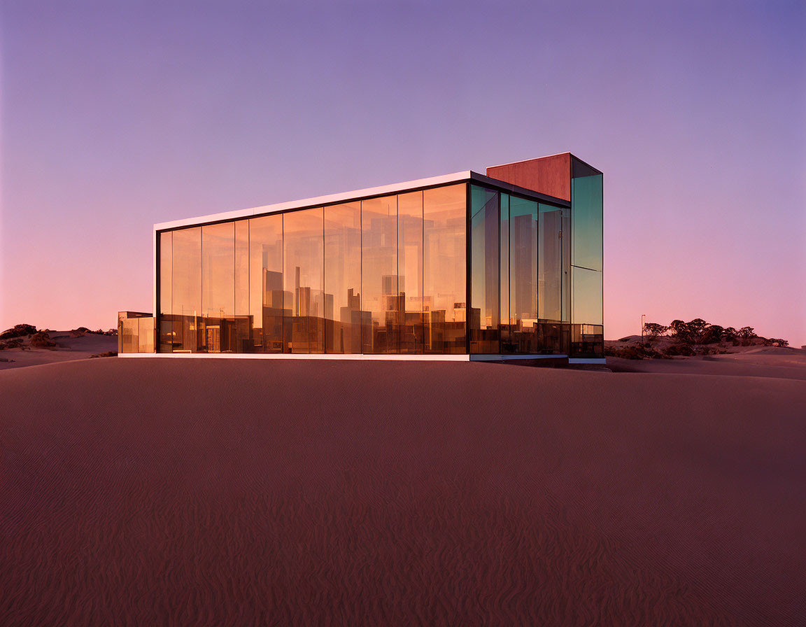 Simplistic modern glass house in tranquil desert landscape at dusk
