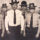 Group of stern police officers in uniform standing in formation