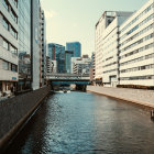 Cityscape: River channel, boats, high-rise buildings, modern architecture