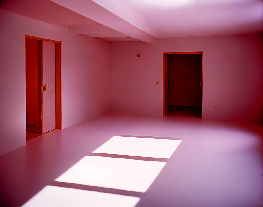Empty Room with Pink Light, Closed Doors, and Sunlight Patches