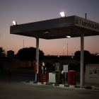 Deserted gas station with vintage fuel pumps at twilight
