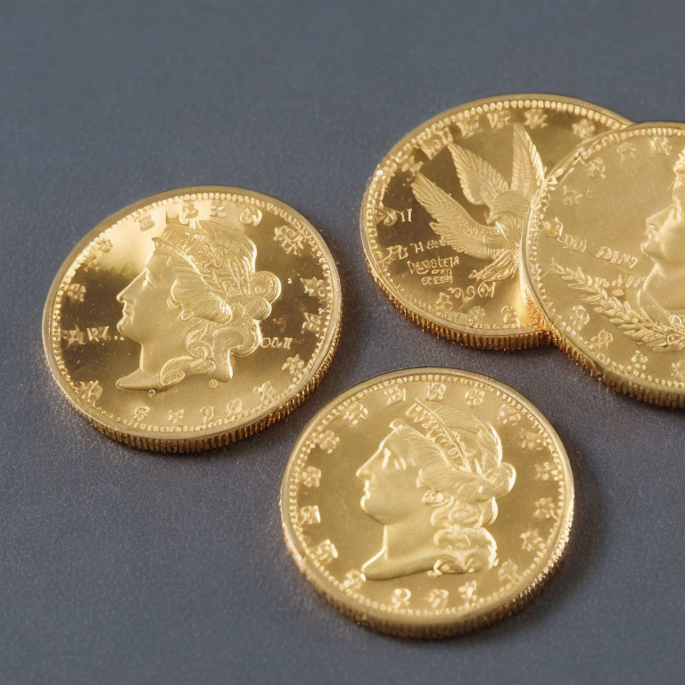 Gold Coins Featuring Lady Liberty Profile, Stars, and Inscriptions on Grey Background