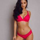 Woman in Red Bikini with Long Dark Hair Pose on Neutral Background