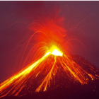 Volcano erupting at night with glowing lava flows and ash plume