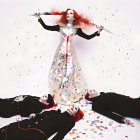 Surreal image: Stylized figure with red hair, white makeup, gold dress, black