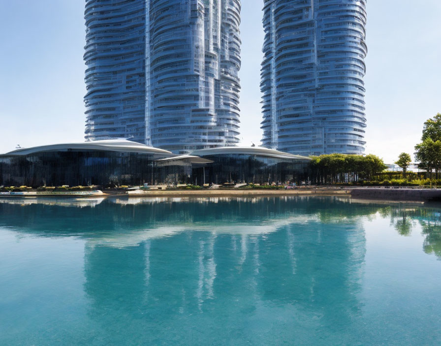 Twin-tower architecture with reflective glass facades near waterfront landscaping