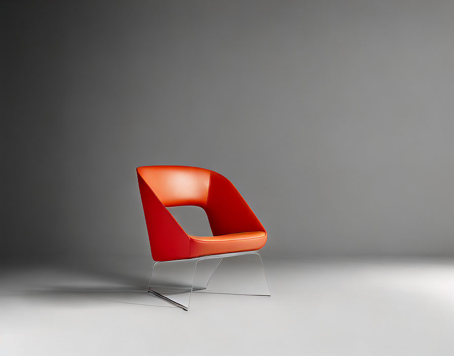 Modern Red Chair with Chrome Base on Gray Background