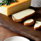 Sliced Cheese Wedge on Wooden Board with Bread and Garnish