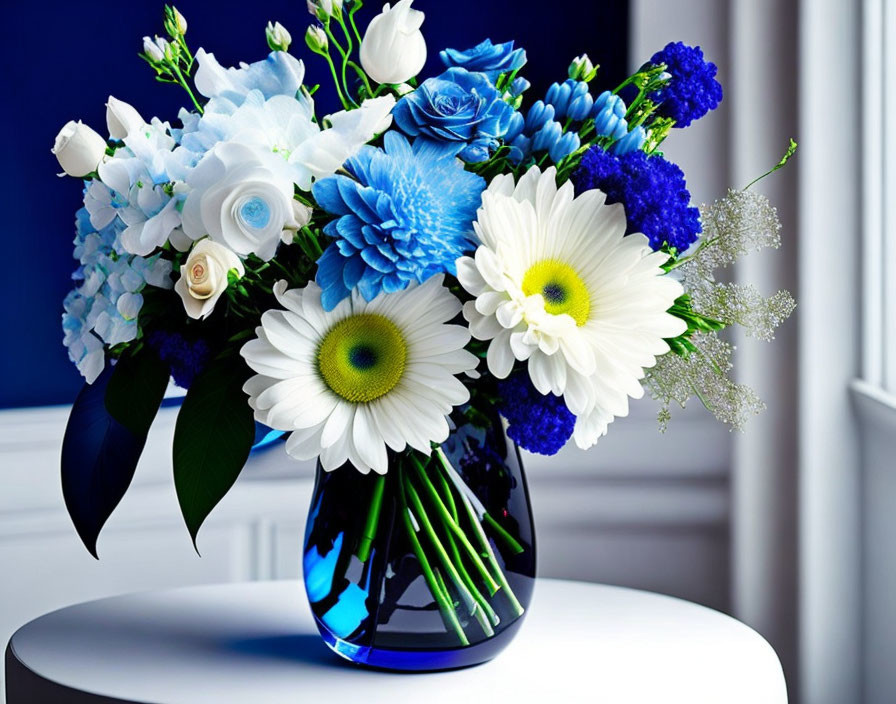 Blue and White Flower Bouquet in Blue Glass Vase on White Surface