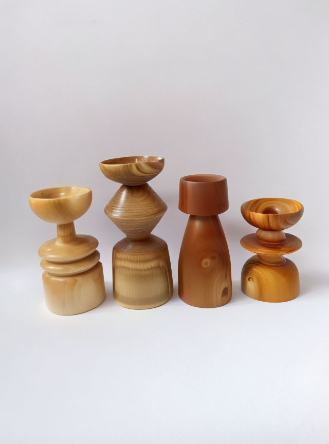 Assorted wooden objects in various shapes and shades on plain background