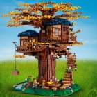 Whimsical treehouse with round rooms, blue roofs, autumn leaves, small birdhouse