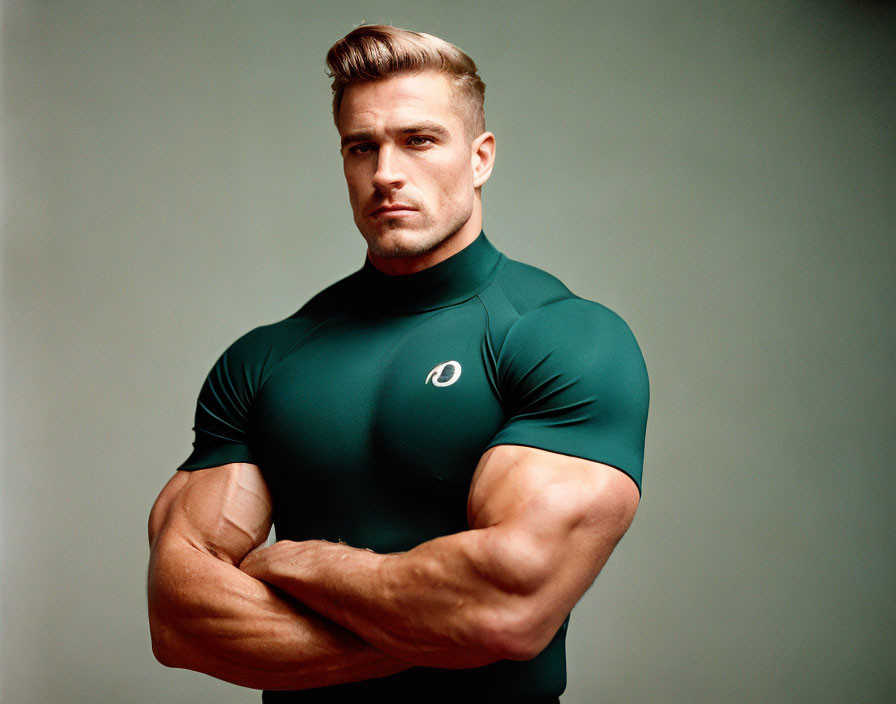 Blond Muscular Man in Green T-Shirt with Crossed Arms