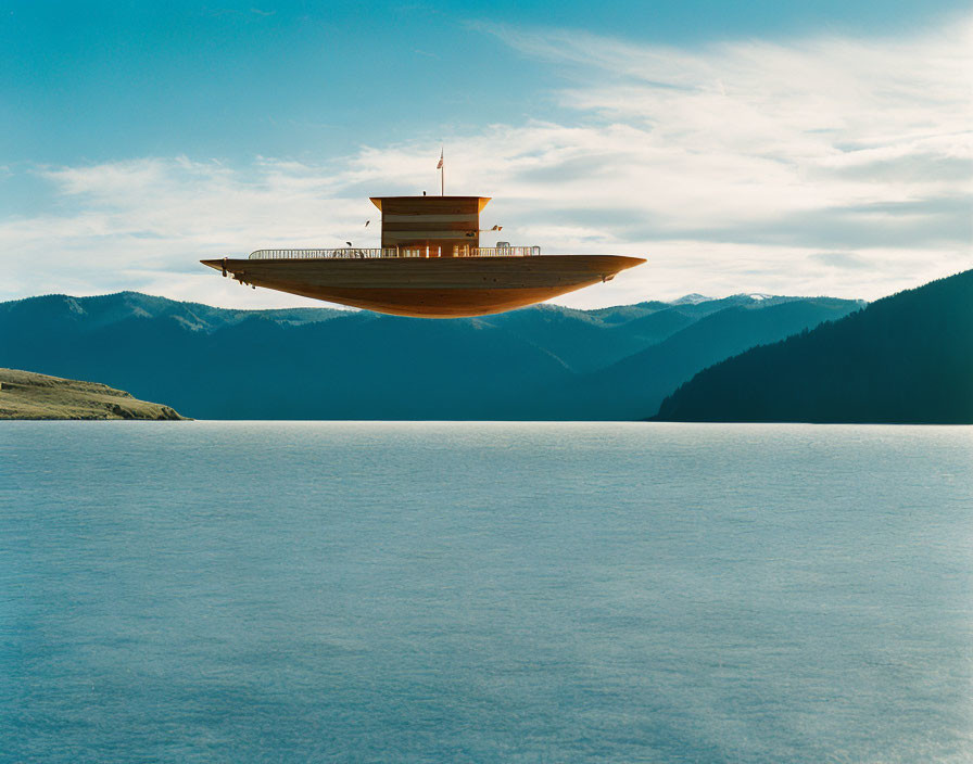 Surreal building resembling ship's bridge over tranquil lake surrounded by mountains
