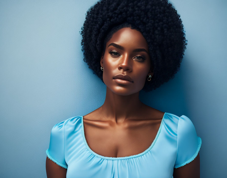 Woman with voluminous afro and puff sleeve top on blue background