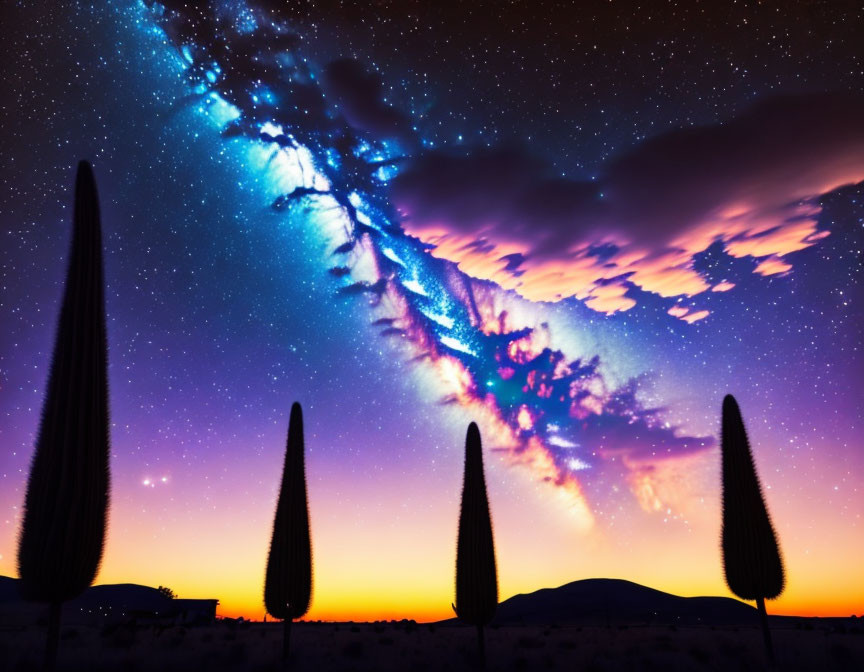 Silhouettes of cacti under twilight sky with Milky Way and clouds