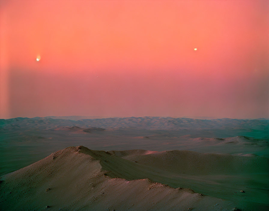 Martian landscape with pink sky, two moons, and sandy dunes