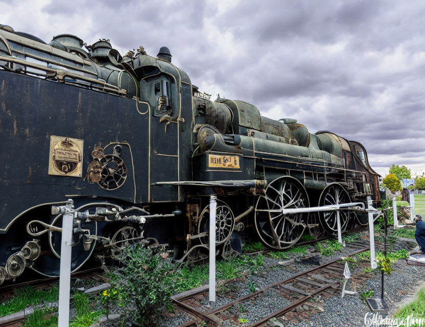 Vintage Black Steam Locomotive with Intricate Details on Tracks