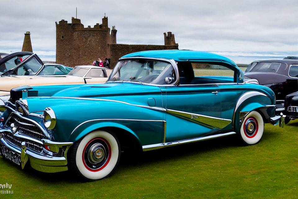 Vintage Teal and White Car with Chrome Details and Whitewall Tires at Classic Car Show