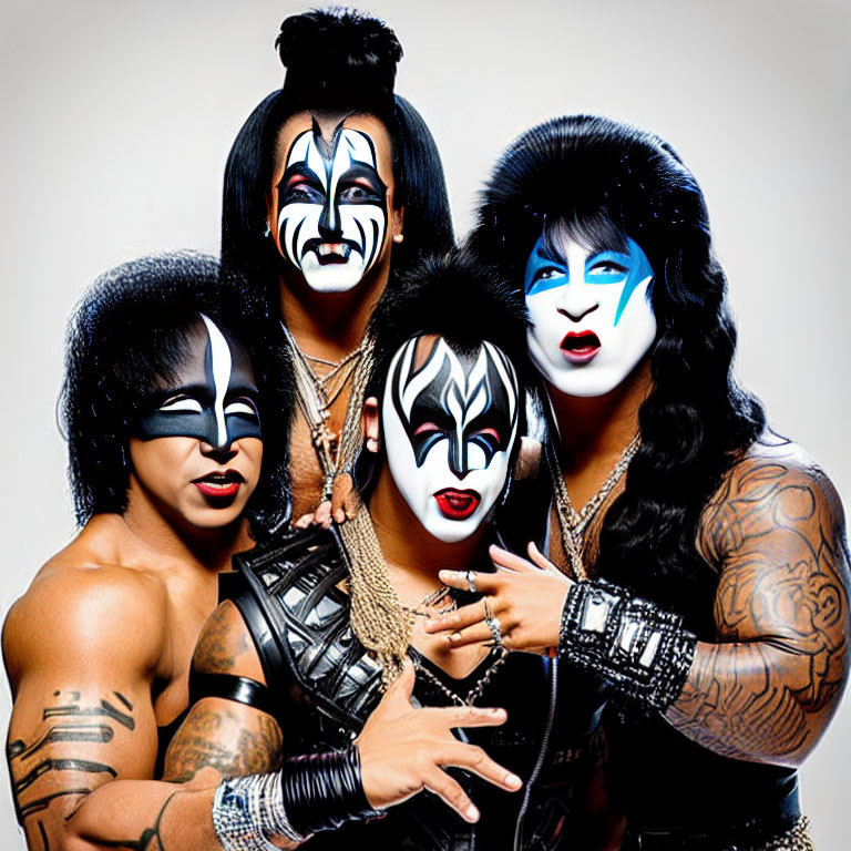 Band members in black and white face paint and flamboyant costumes pose for a photo