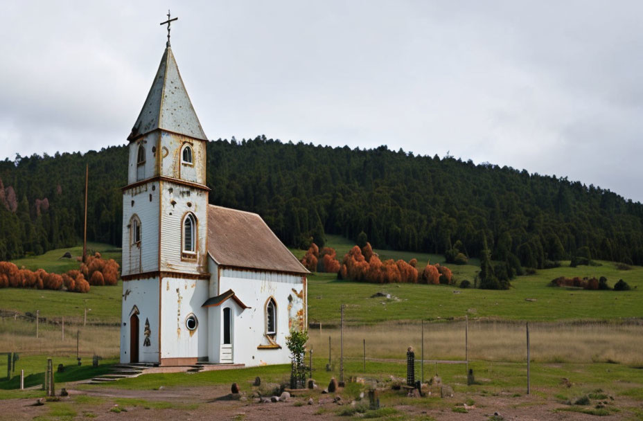 White Church with Pointed Steeple in Green Landscape & Forested Hills