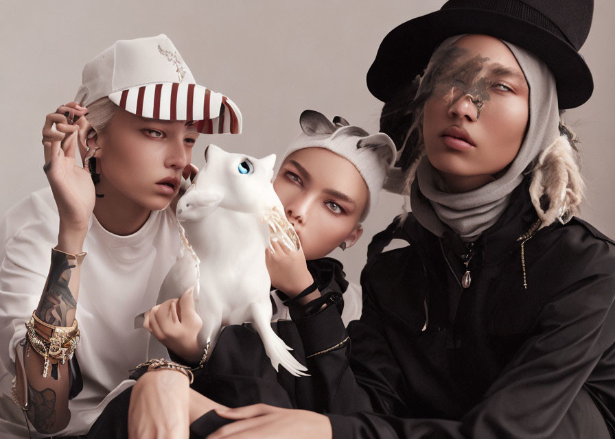 Fashionable Trio Poses with White CGI Cat in Stylish Hats