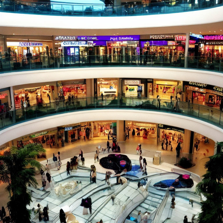 Multi-level shopping mall with bright signage and fountain centerpiece.