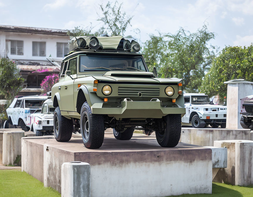 Military-style green vehicle with roof-mounted rocket launcher on concrete platform