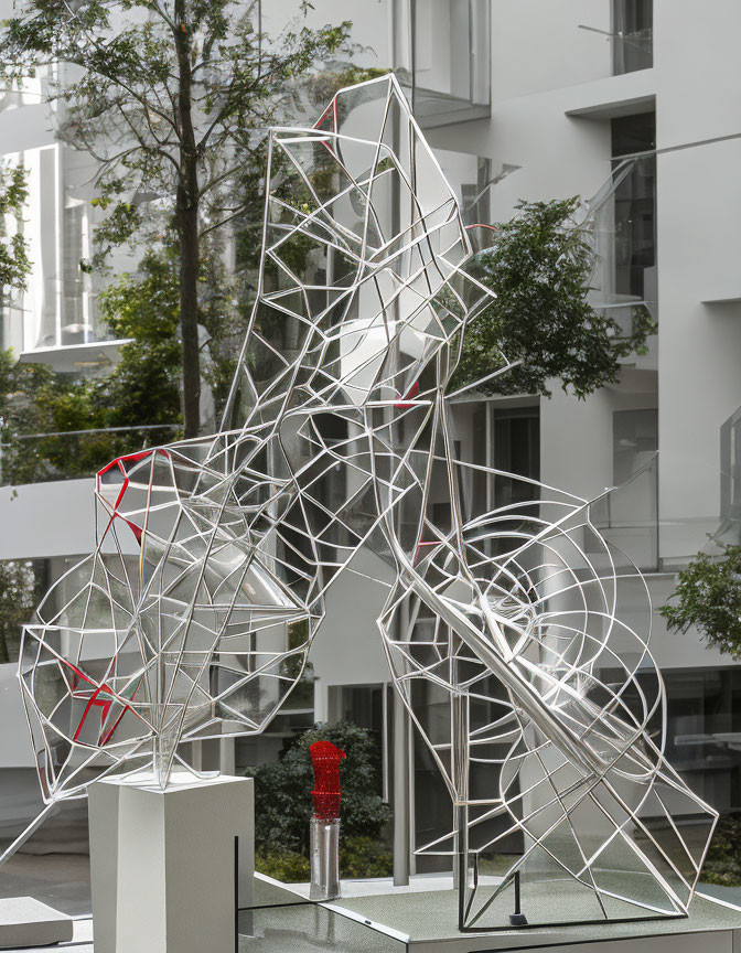 Geometric Metal Sculpture of Interconnected Crystalline Shapes in Bright Courtyard